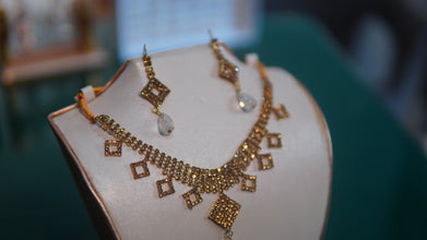 Golden Gold-toned necklace and matching earrings